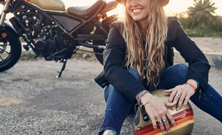 Paige Mycoskie posing in front of a motorcycle