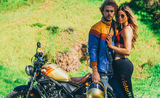 Two models posing in front of a motorcycle