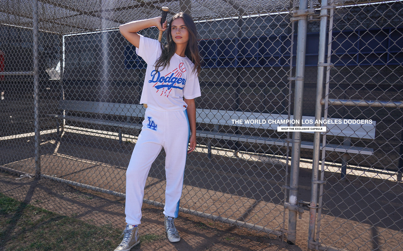 Person wearing a Los Angeles Dodgers uniform in a dugout.