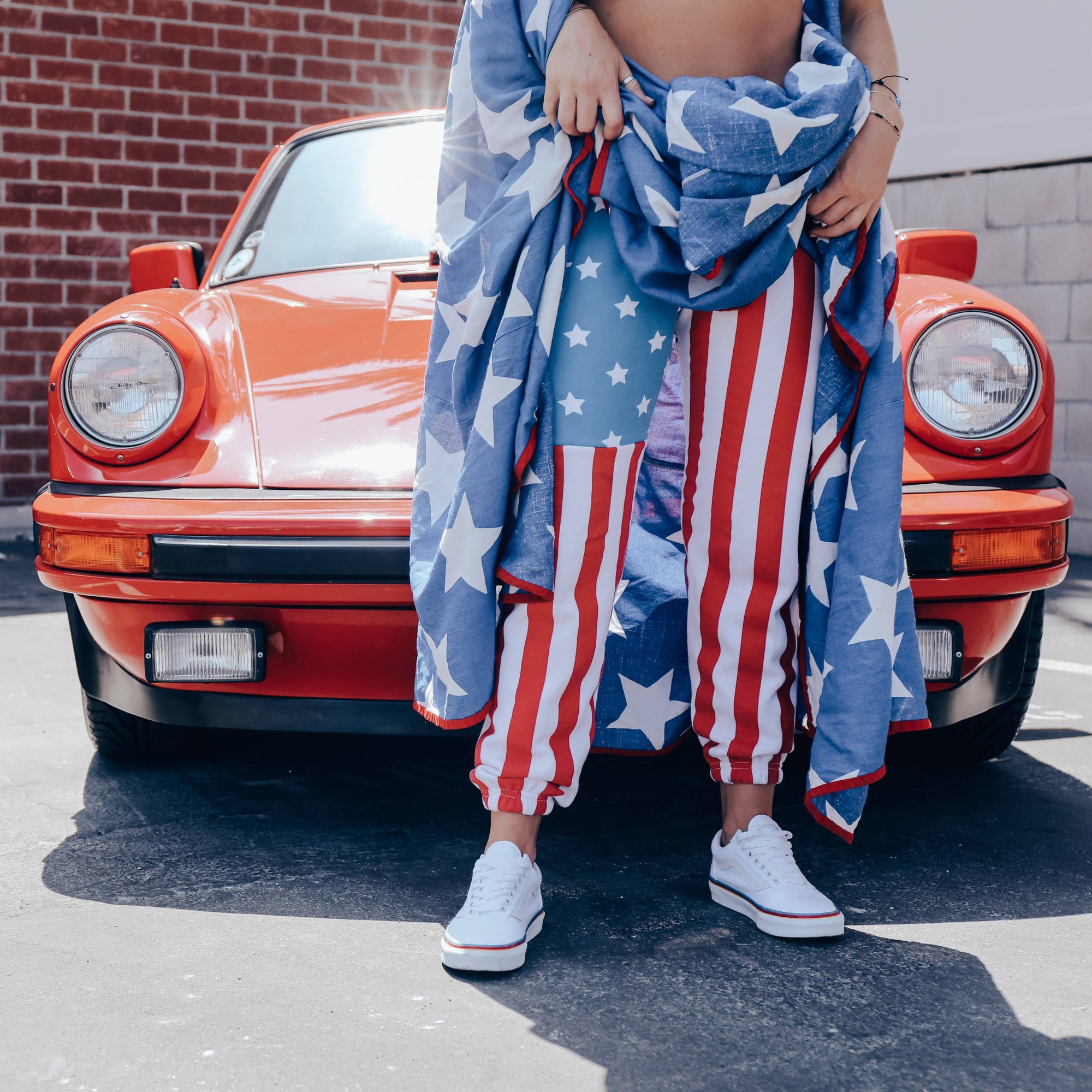 American flag sweatpants in-front of a car