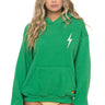 Woman wearing a green hoodie with a white lightning bolt design on a white background