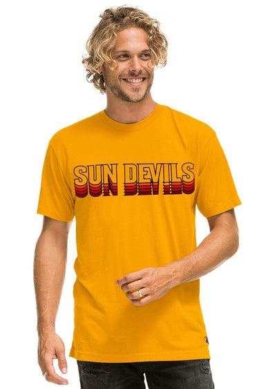 Man wearing a yellow t-shirt with 'Sun Devils' text on a white background